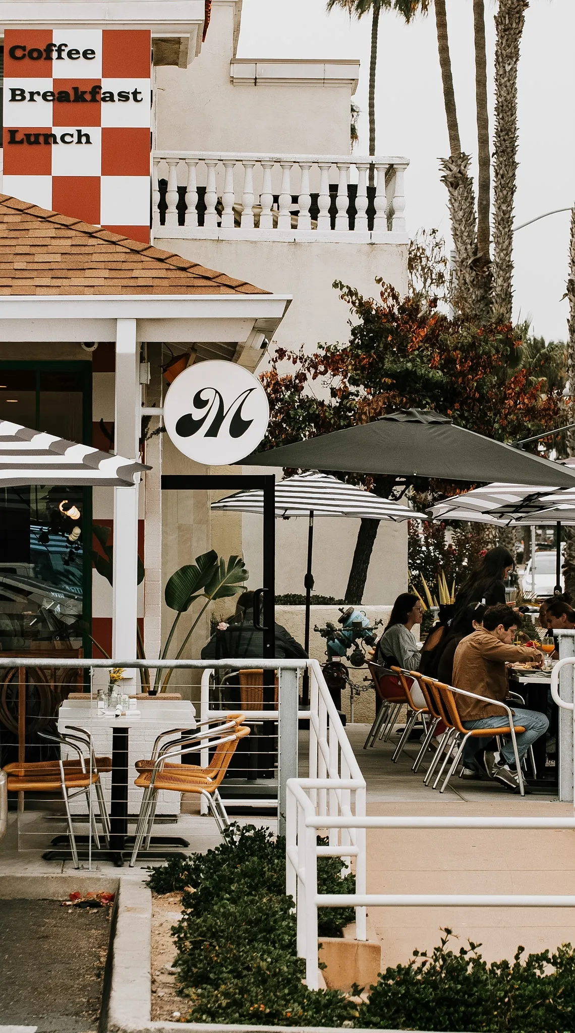 Cafe storefront with palm trees