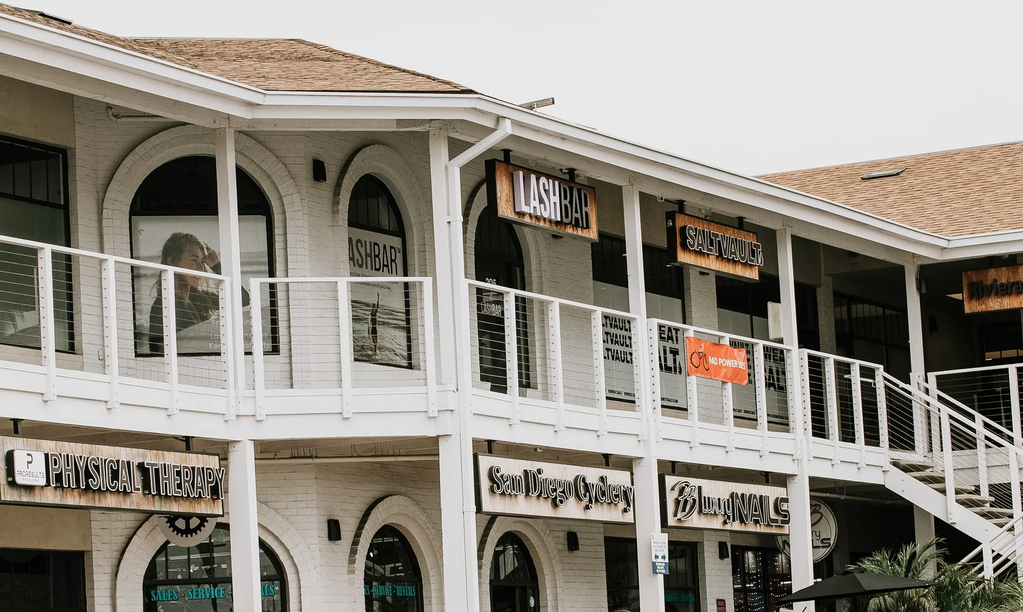 Two-story retail center detail with signage