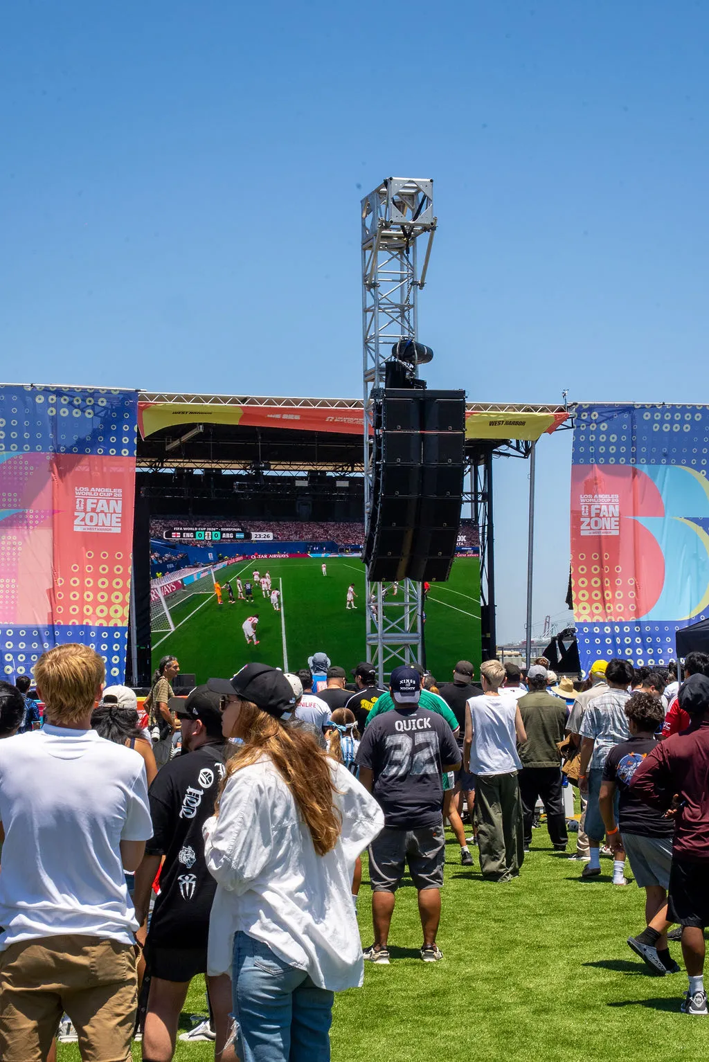Crowd on the lawn watching a World Cup match on the fan zone screen